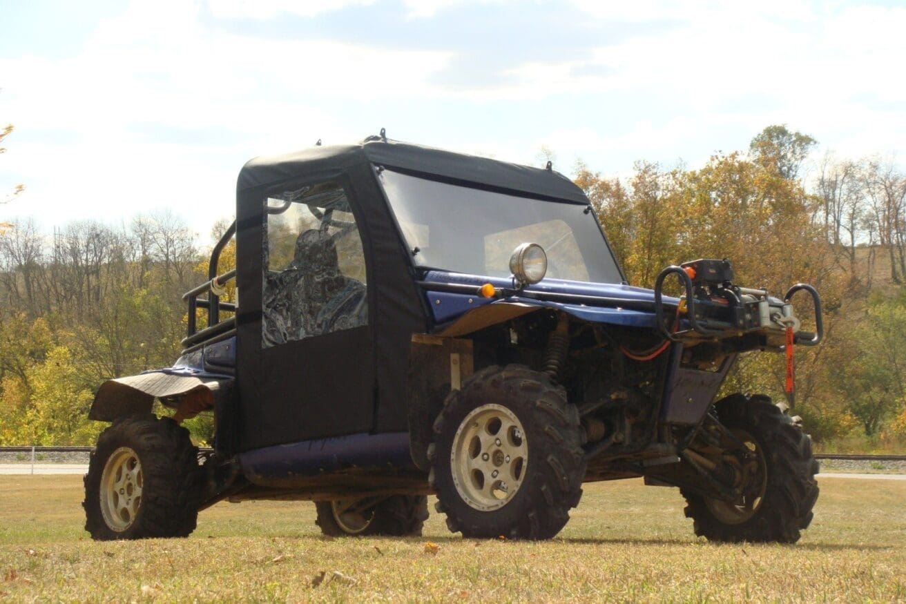 Off-road vehicle parked on grassy field.