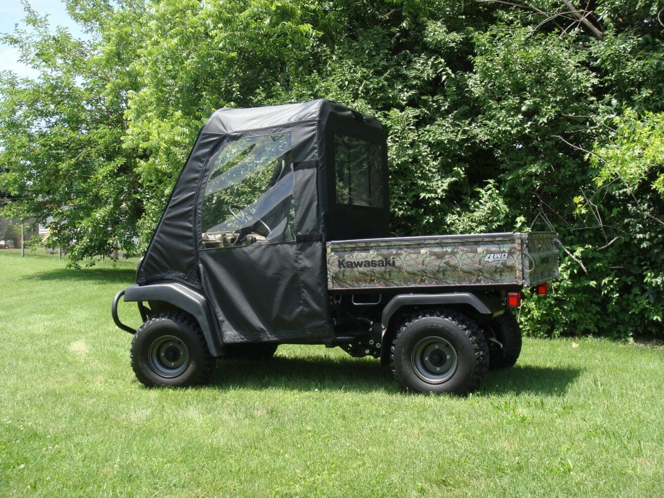 Camouflaged Kawasaki Mule utility vehicle.