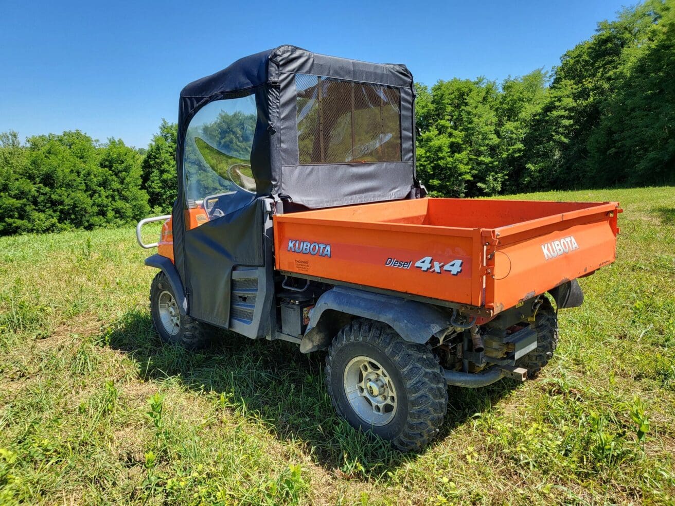 Orange Kubota 4x4 utility vehicle.