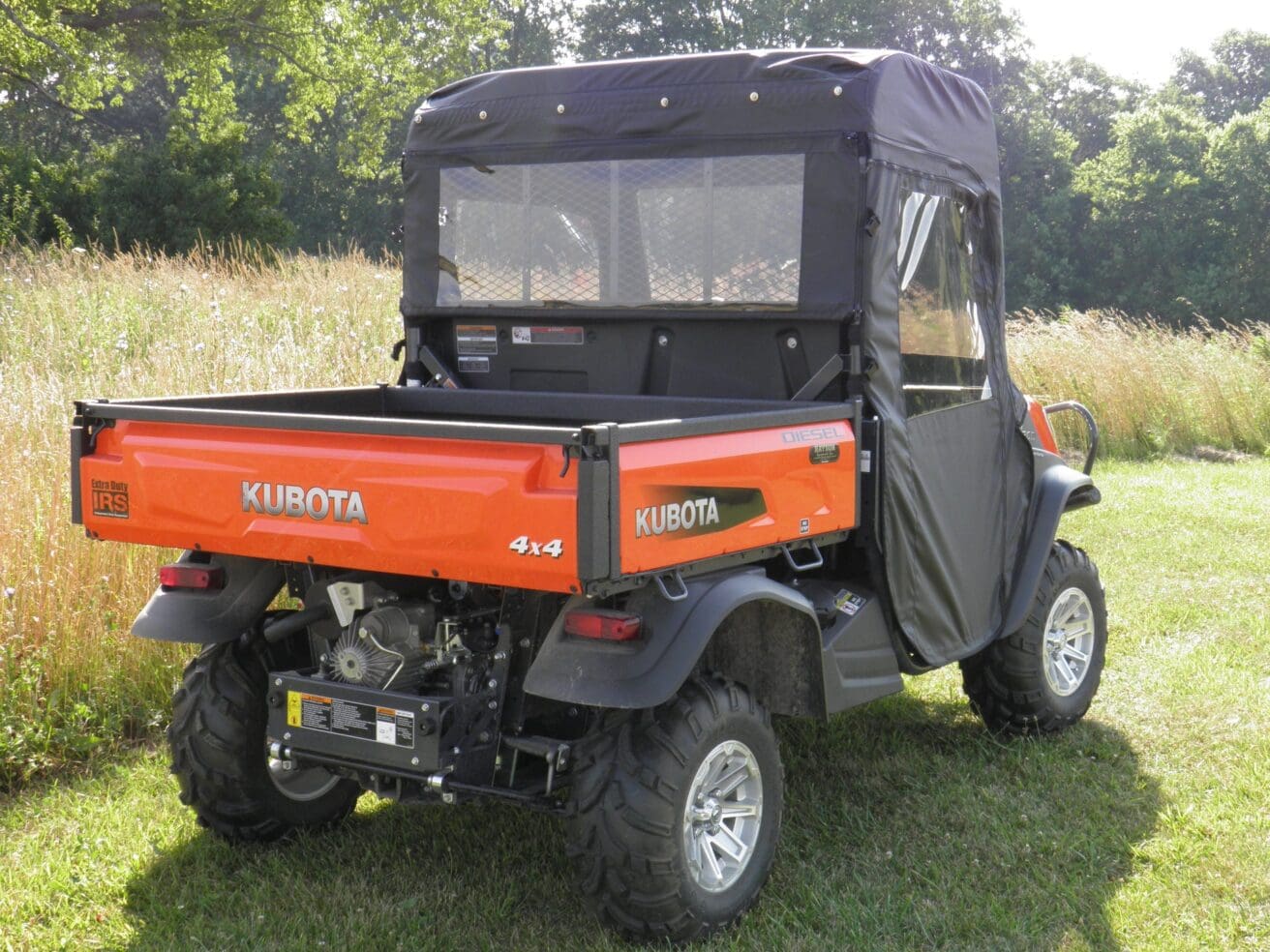 Orange Kubota RTV with cab enclosure.