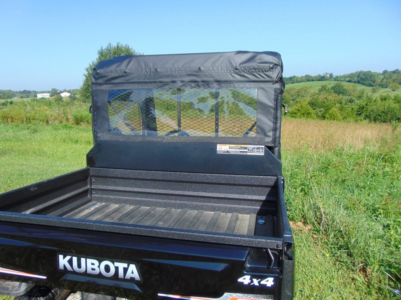 Kubota 4x4 utility vehicle back view.