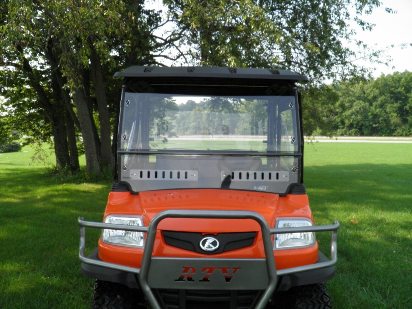 Orange RTV utility vehicle with windshield.