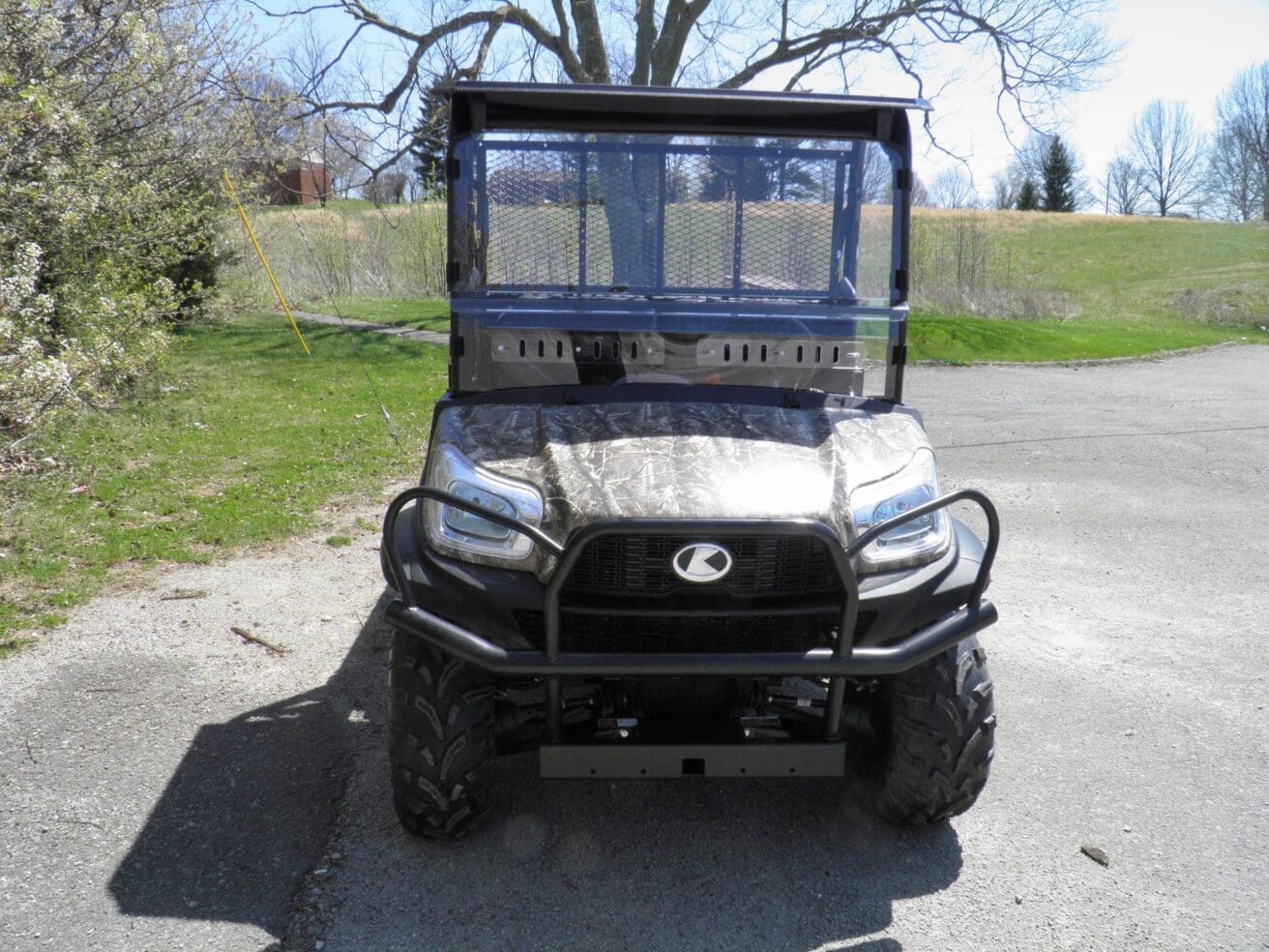 Camouflaged Kawasaki Mule utility vehicle.