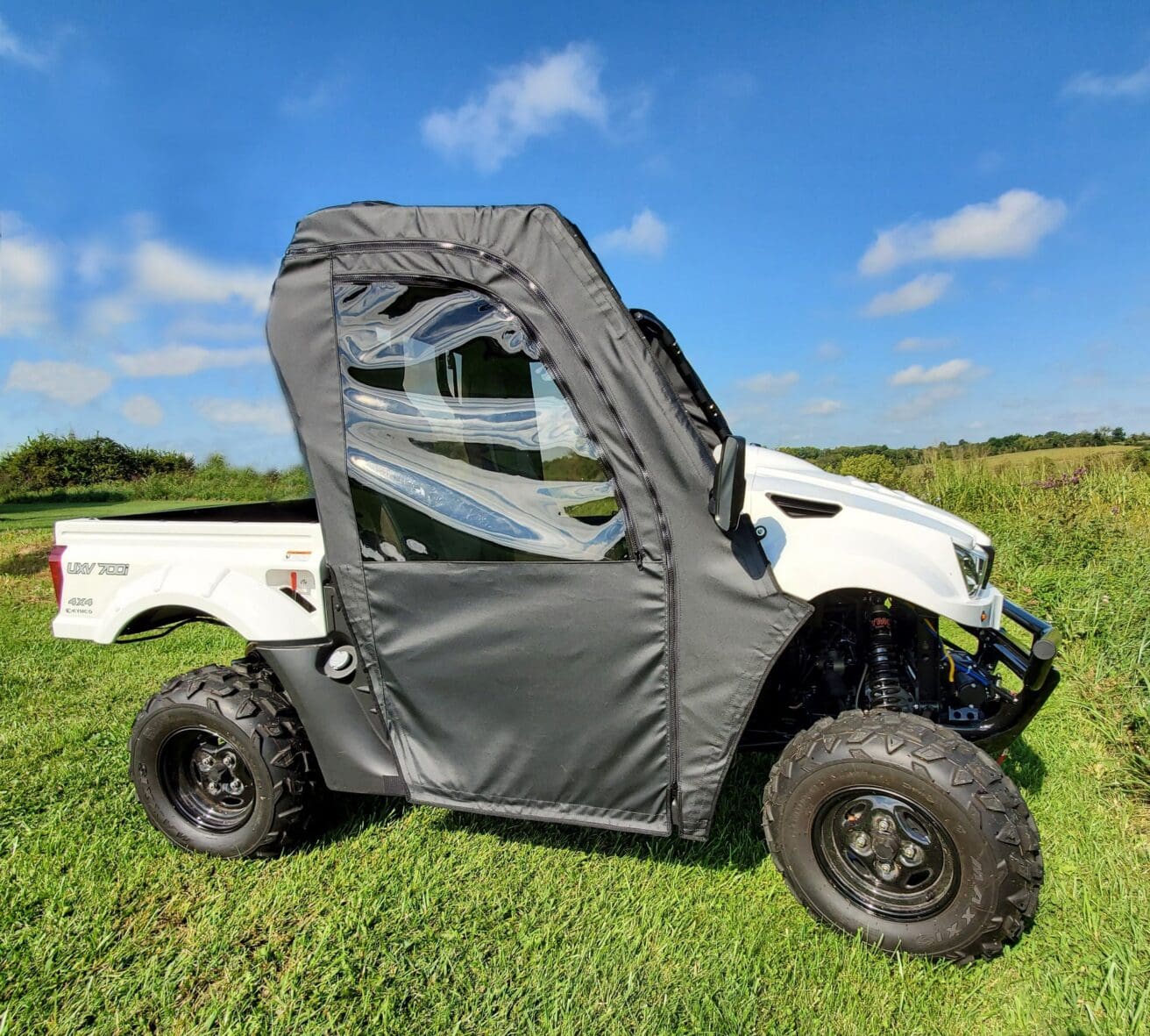 White UTV with black doors and wheels.