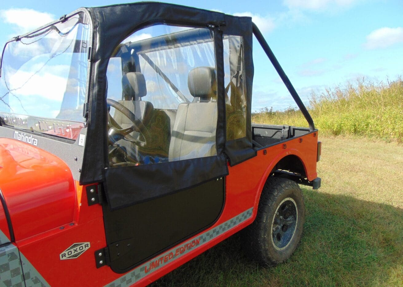 Red Mahindra Roxor with black doors.