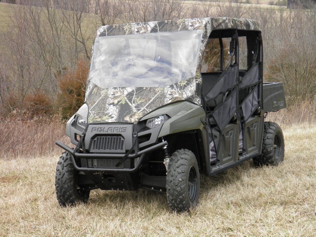 Camouflaged Polaris Ranger in a field.