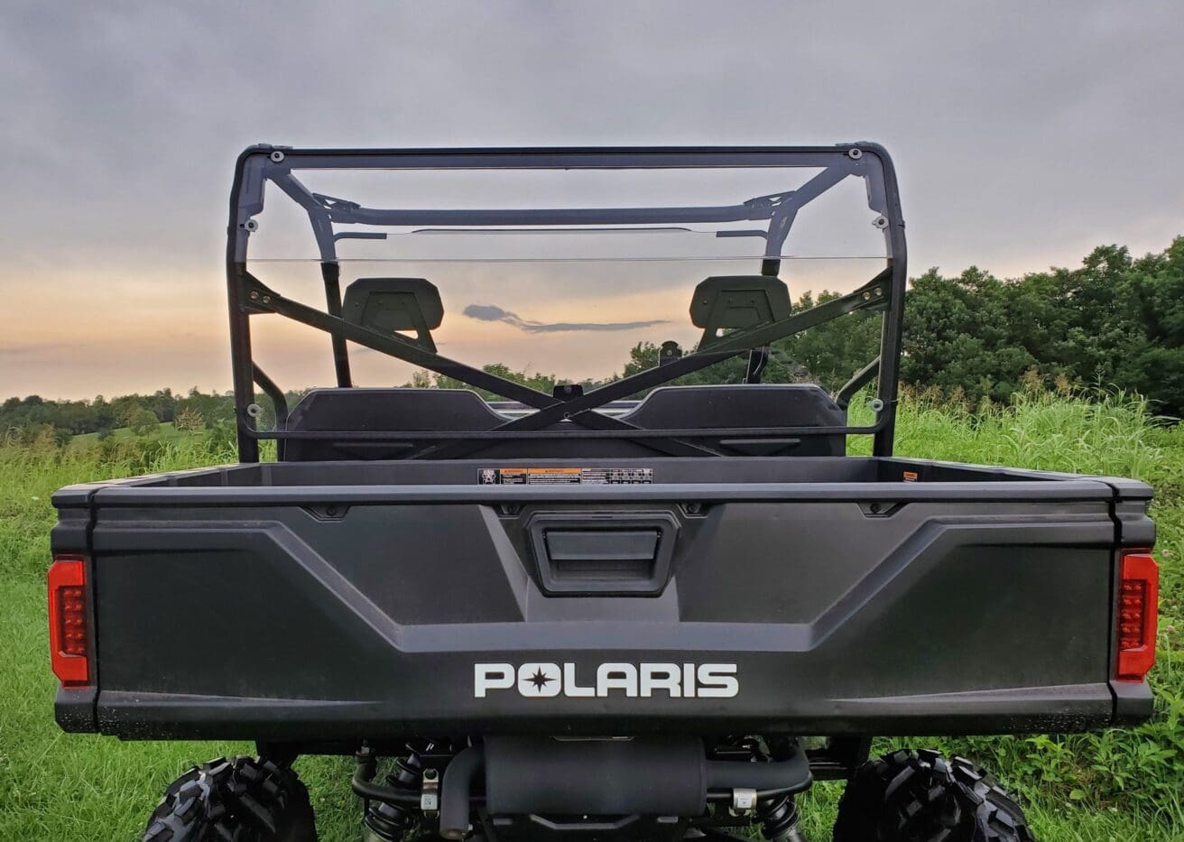 Black Polaris Ranger with rear window.