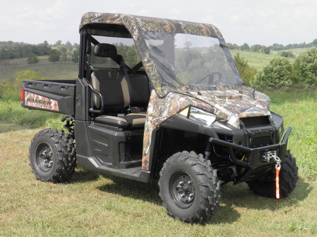 Camouflaged Polaris Ranger with a windshield.