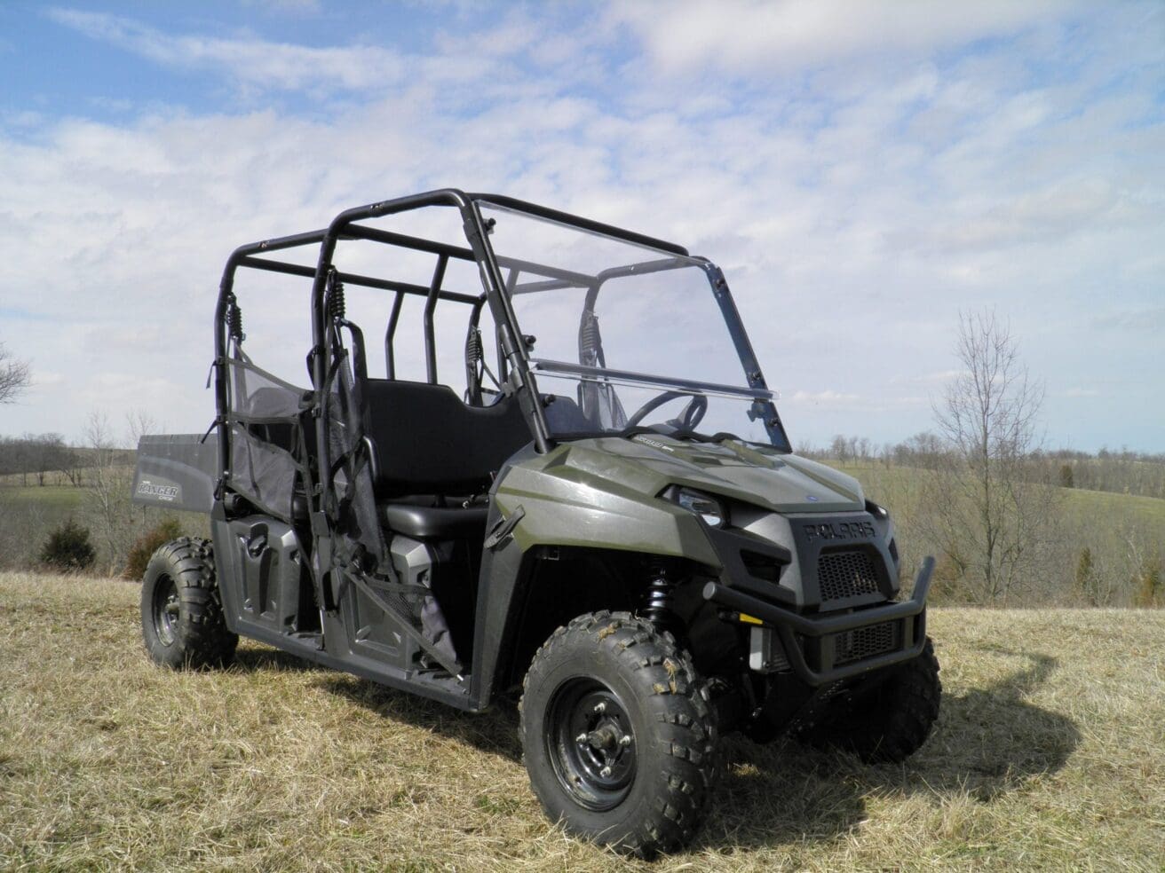 Green Polaris Ranger in a field.