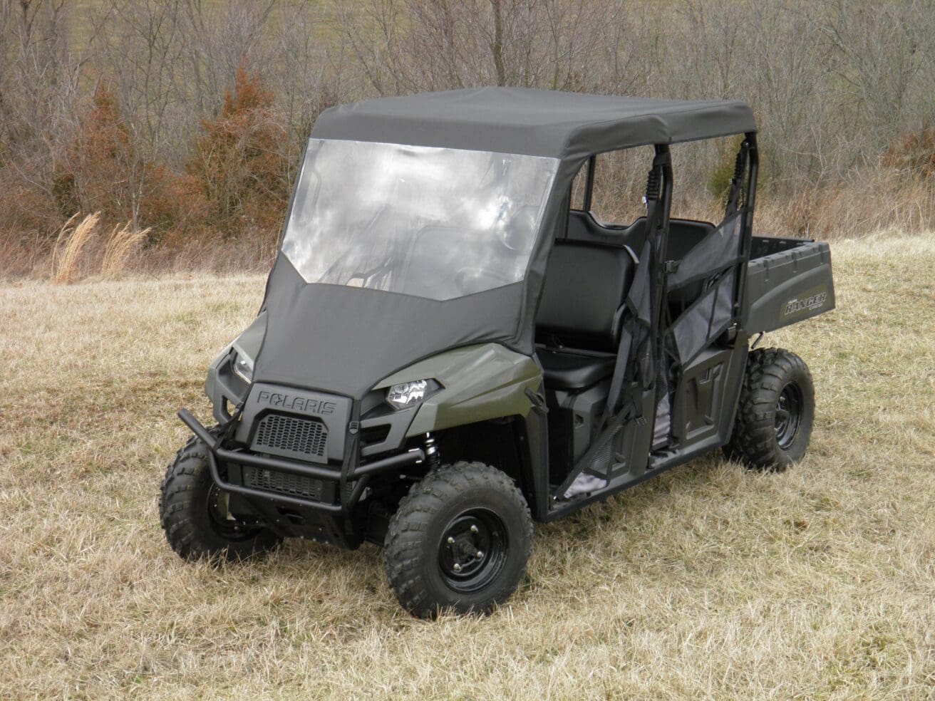 Green Polaris Ranger in field.