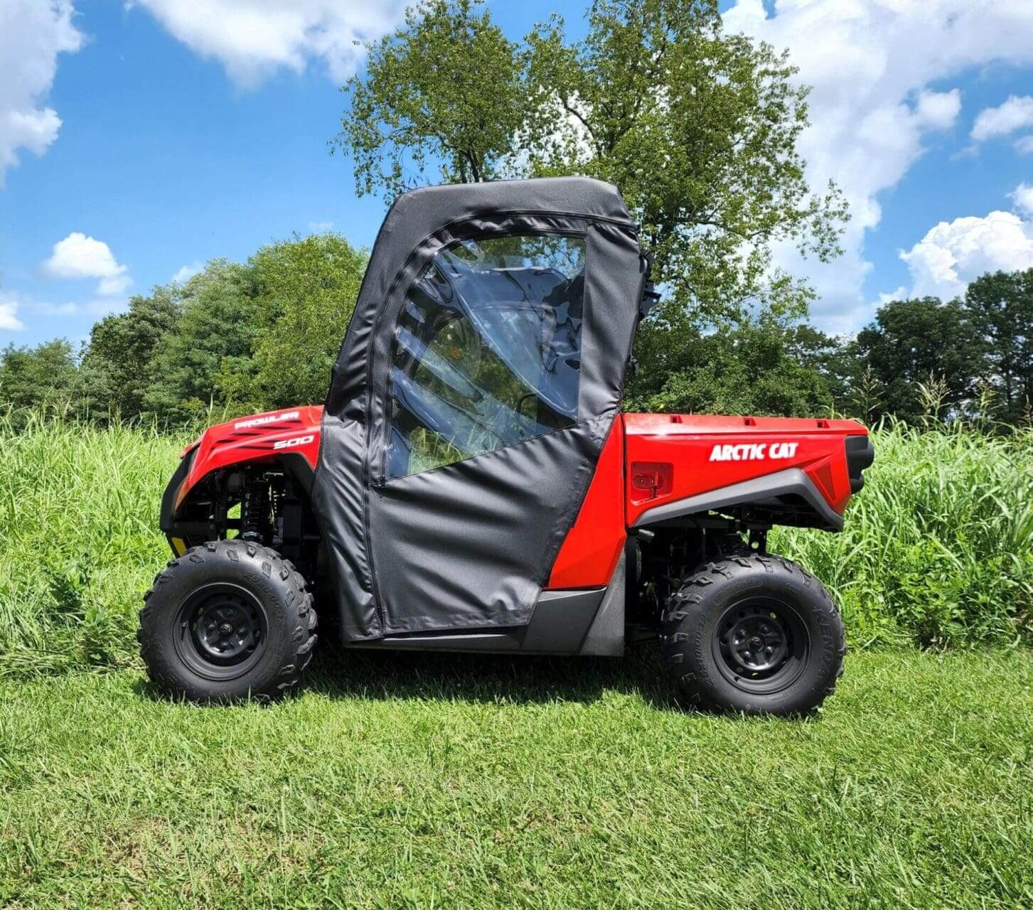 Red Arctic Cat Prowler 500 with cab enclosure.