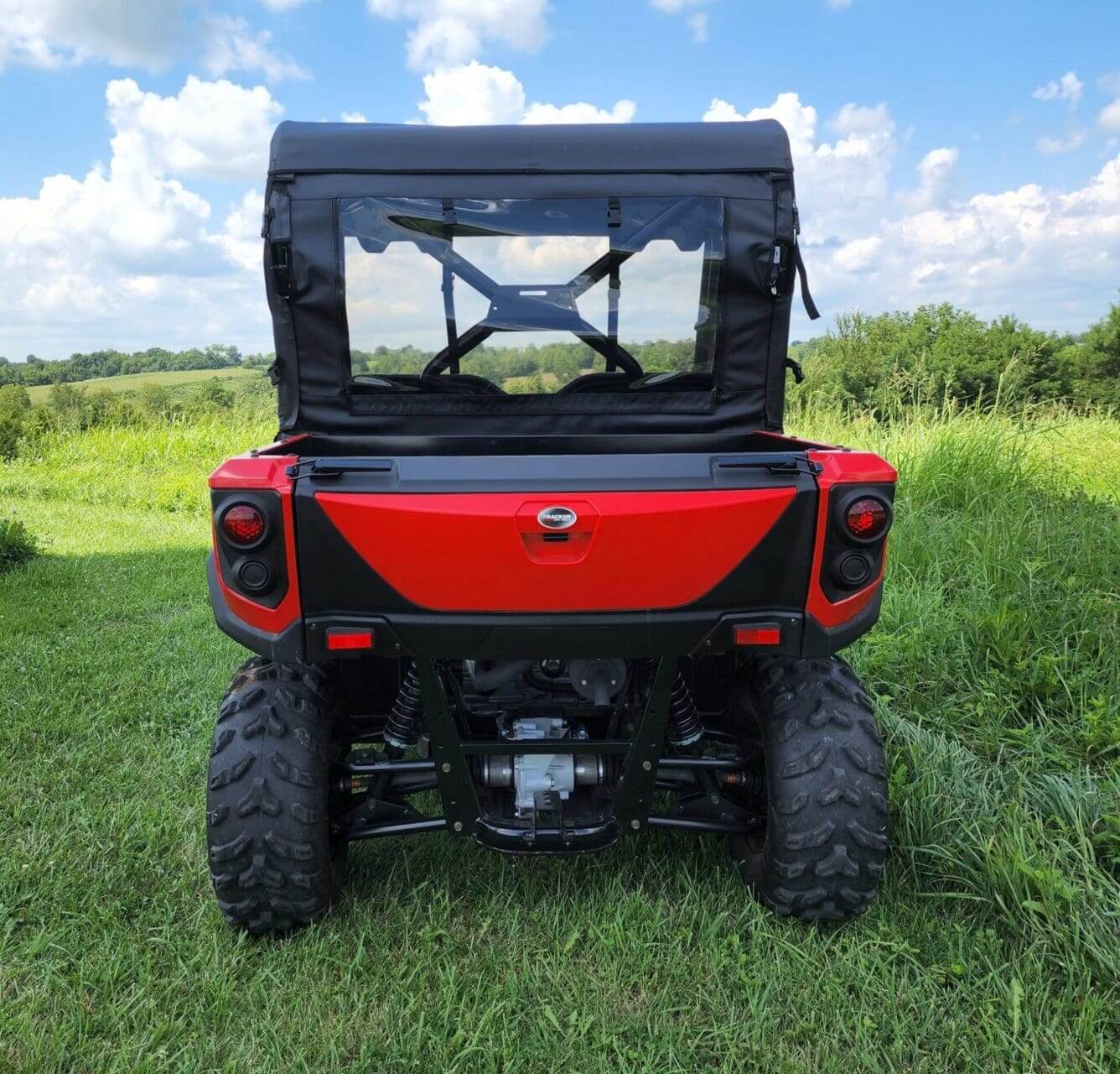 Red Tracker ATV rear view, enclosed.
