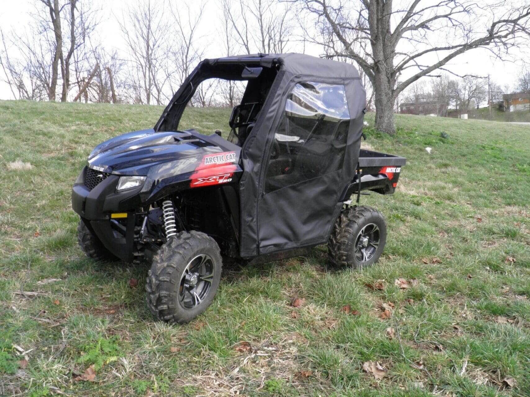 Black Arctic Cat 550 ATV in field.