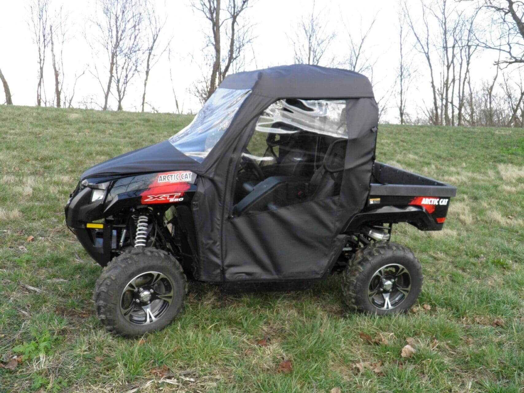 Black Arctic Cat side-by-side with doors.