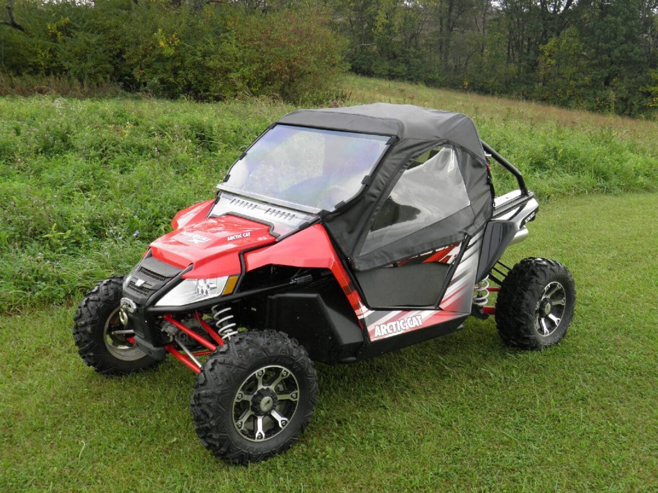Red Arctic Cat Wildcat with cab enclosure.