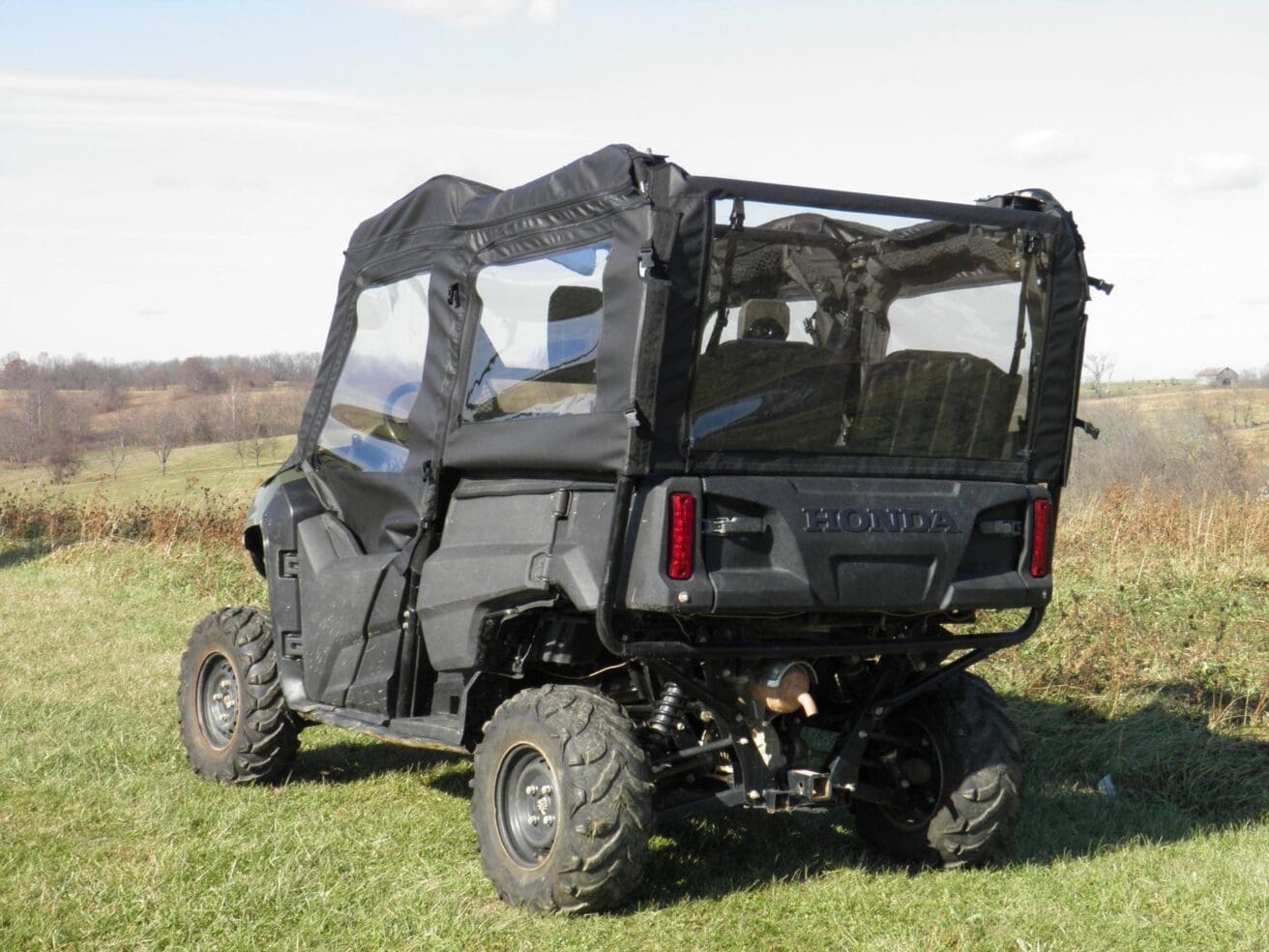 Black Honda Pioneer side-by-side ATV.