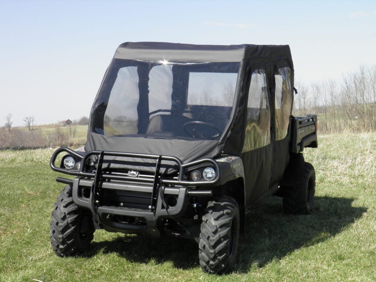 Black enclosed utility vehicle in field.