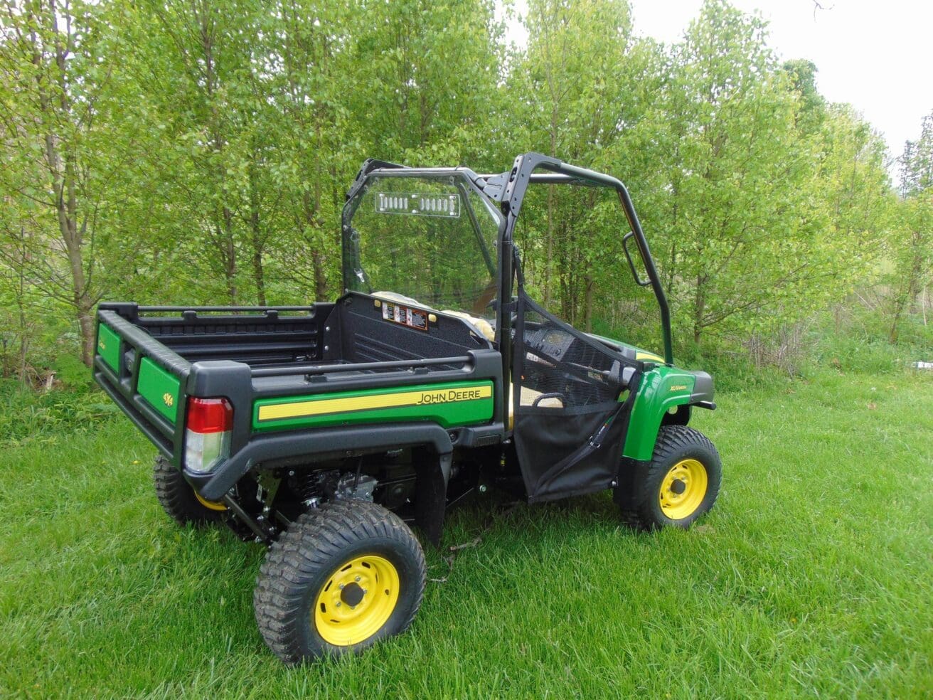 John Deere Gator utility vehicle in field.