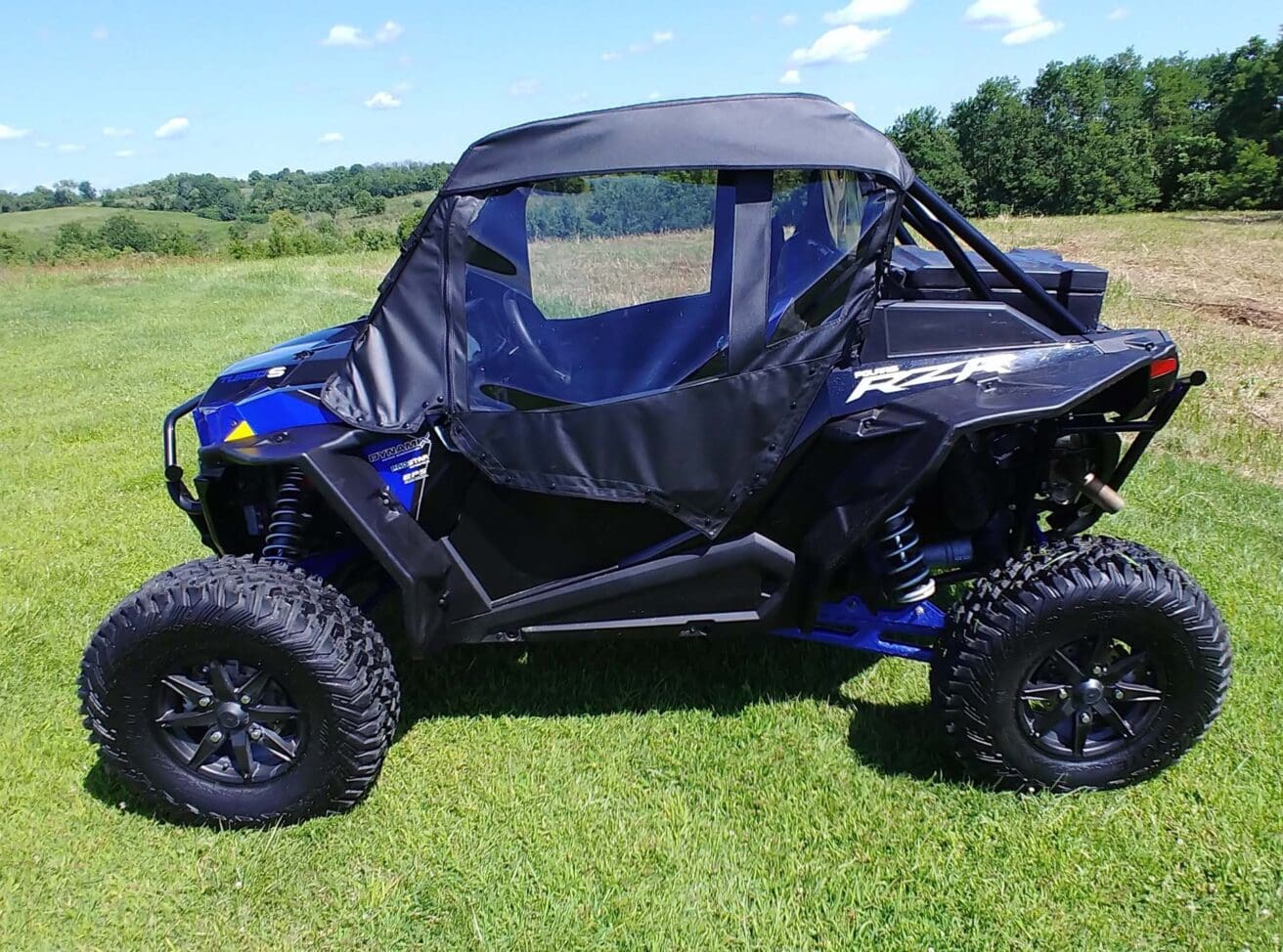 Blue Polaris RZR with full enclosure.