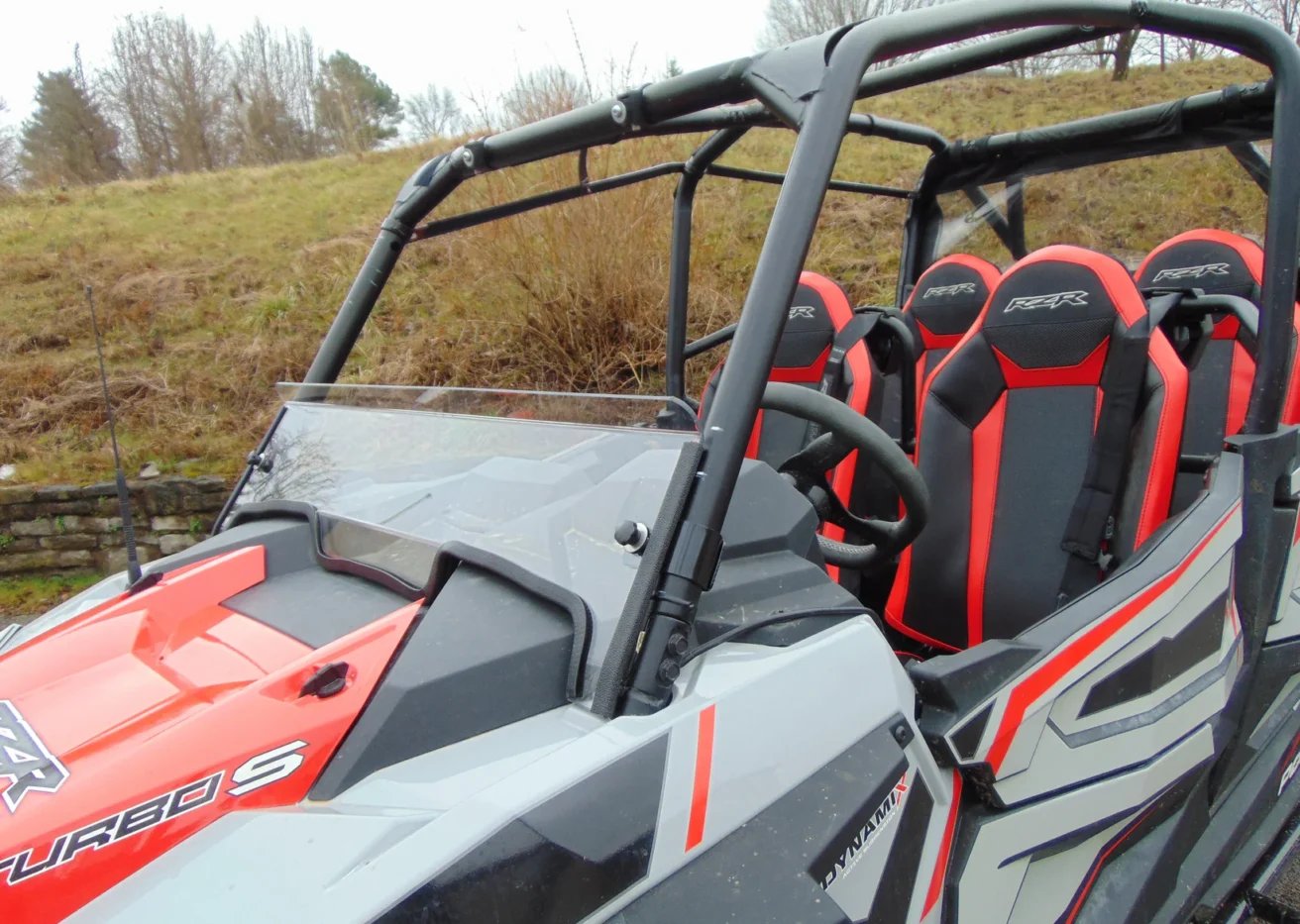 Red and grey Polaris RZR Turbo S with windshield.