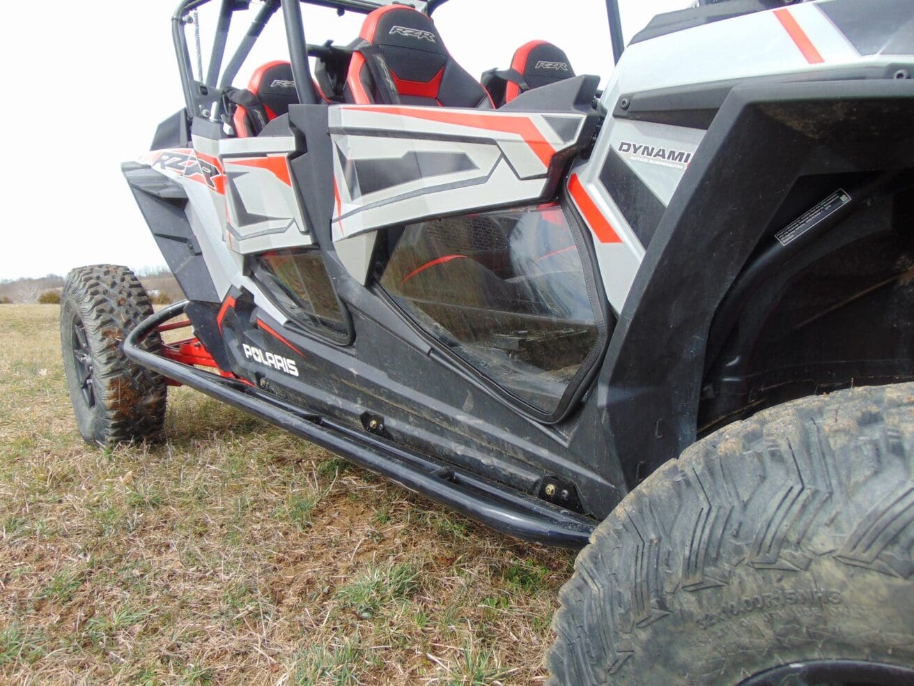 Polaris RZR side profile with rock sliders.