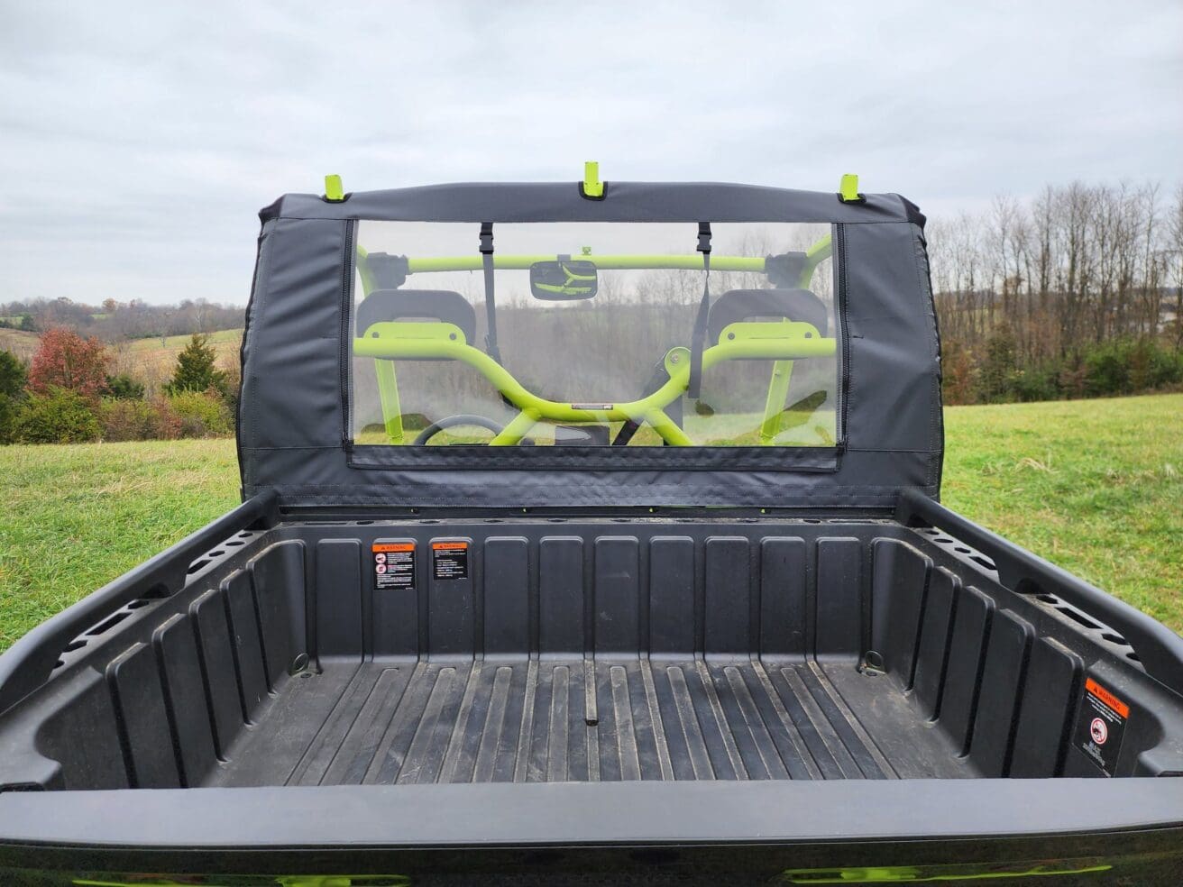 Here's an alt tag for the image: ATV rear window and cargo bed.