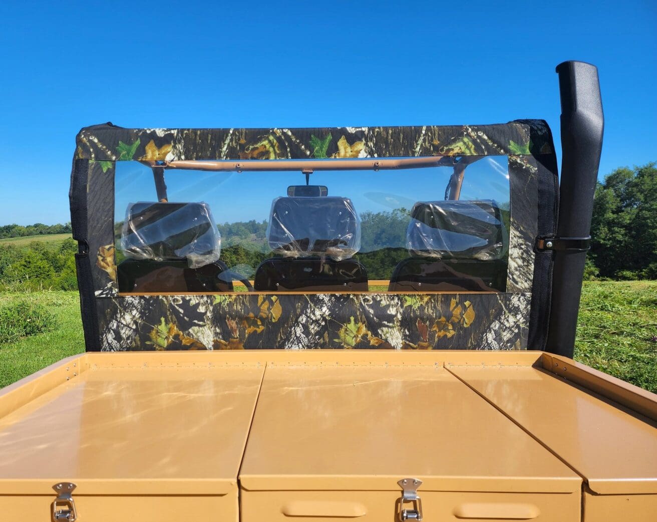 Camouflaged utility vehicle rear view.