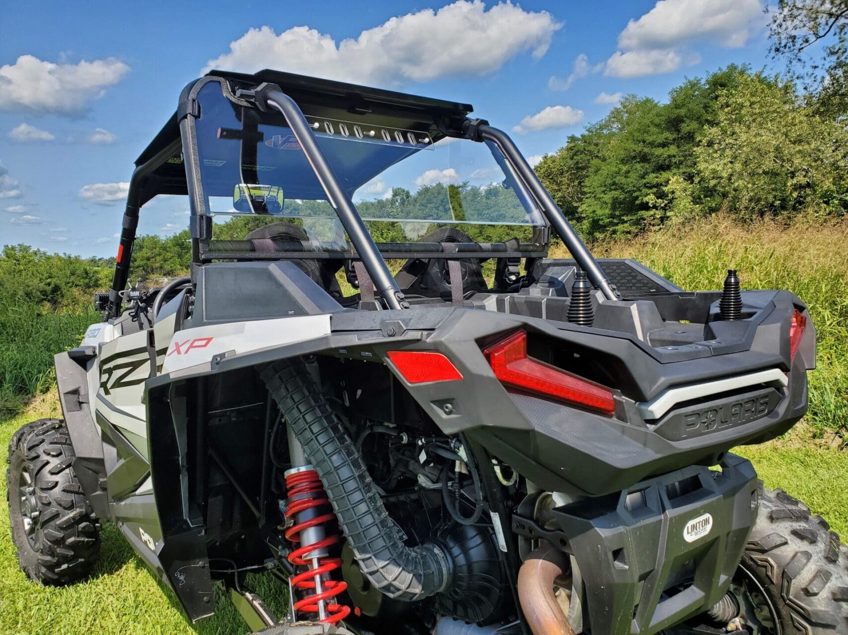 Gray off-road UTV parked on grassy field