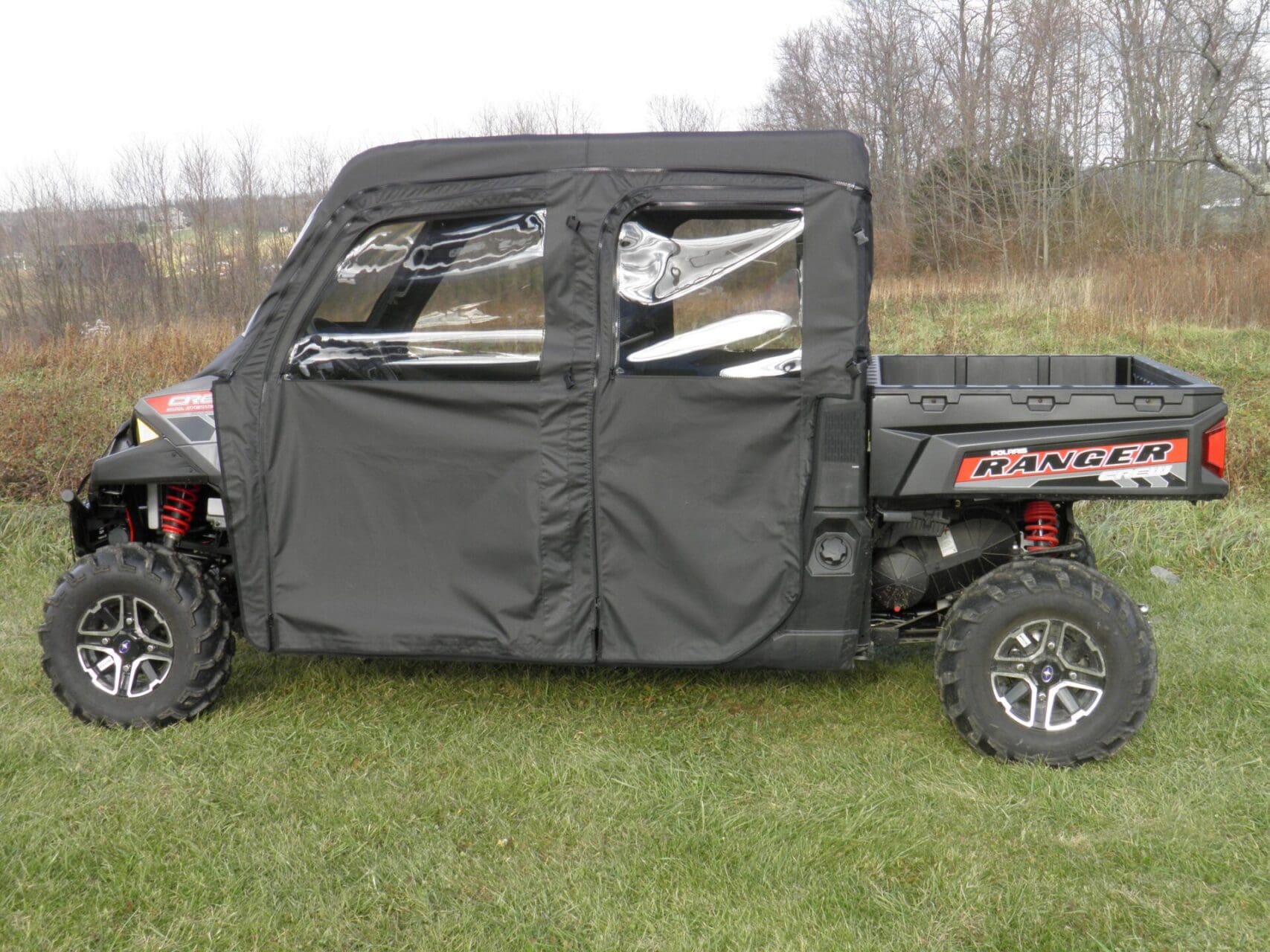 Black enclosed Polaris Ranger UTV on grass