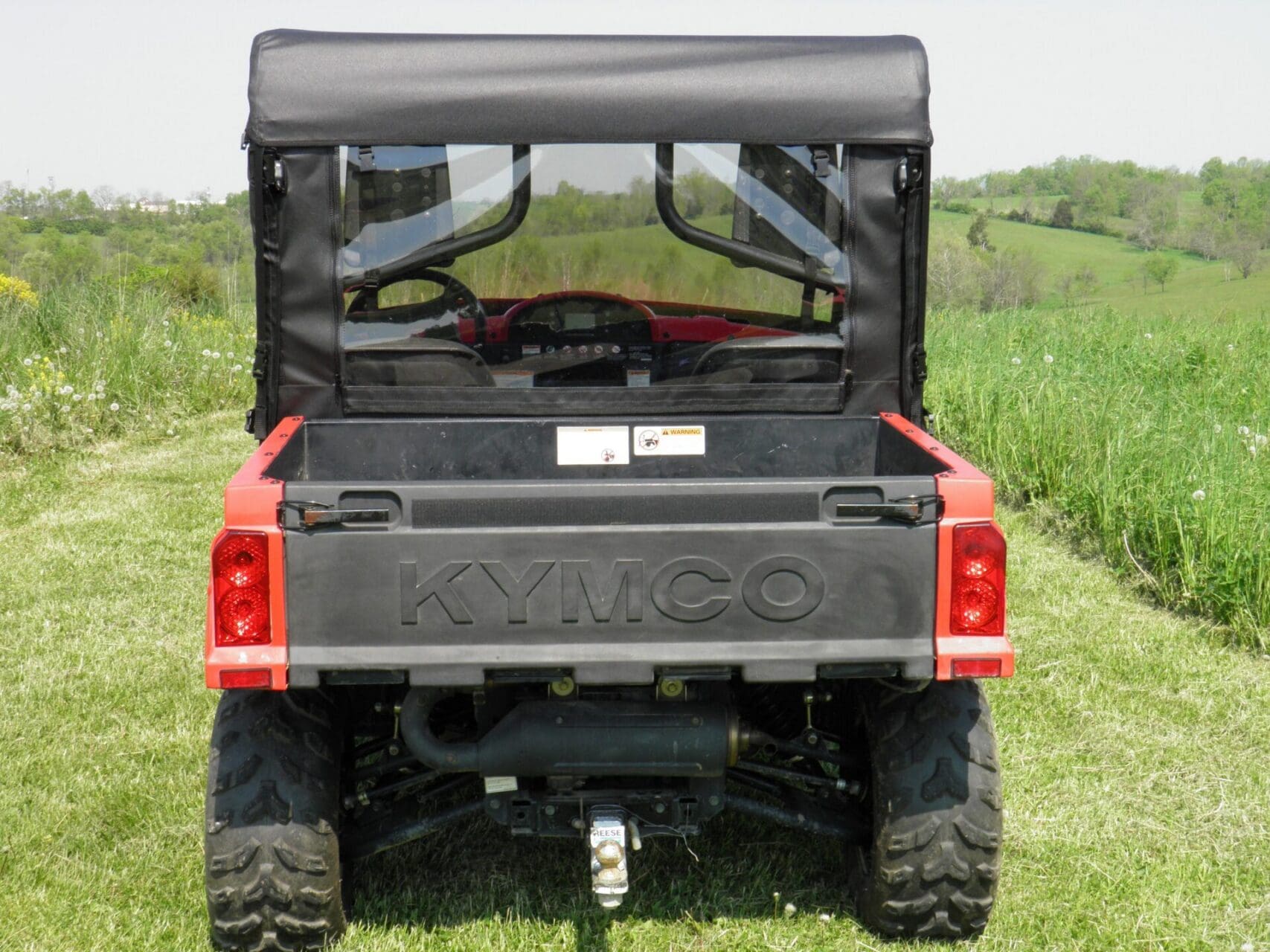 KYMCO utility vehicle with soft rear enclosure.