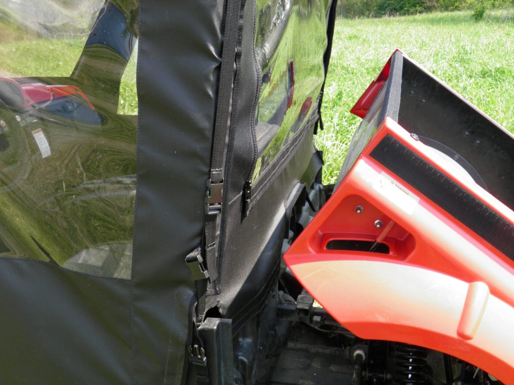Zippered side access on utility vehicle enclosure.