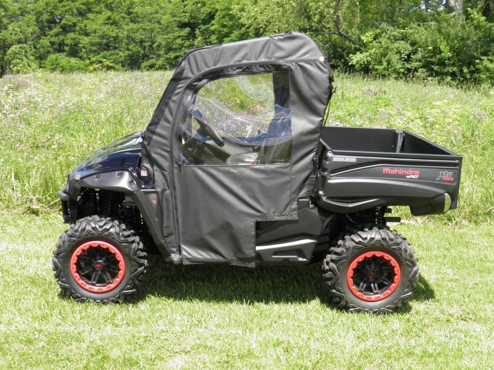 Utility vehicle with soft enclosure and windshield.