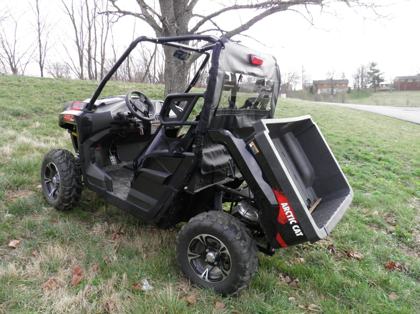 Black Arctic Cat UTV with raised cargo bed