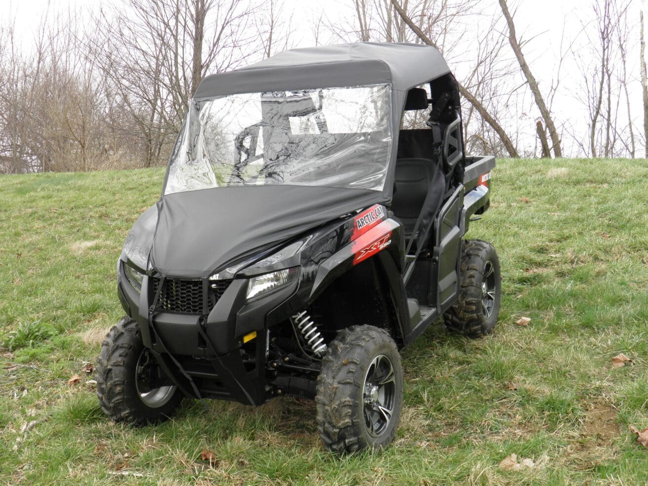 Black side-by-side UTV on grassy field