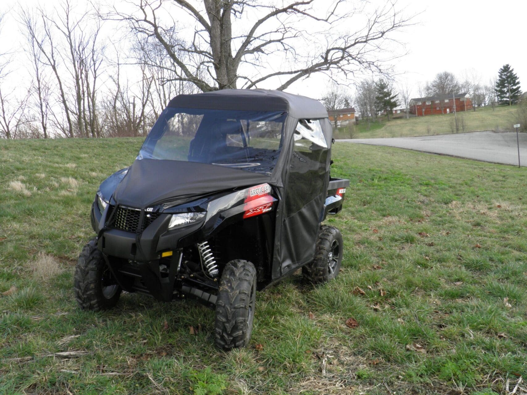 Parked black side-by-side UTV on grass