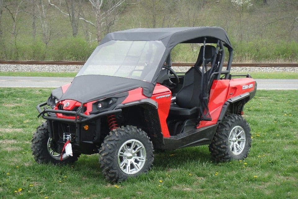 Red off-road side-by-side UTV on grass