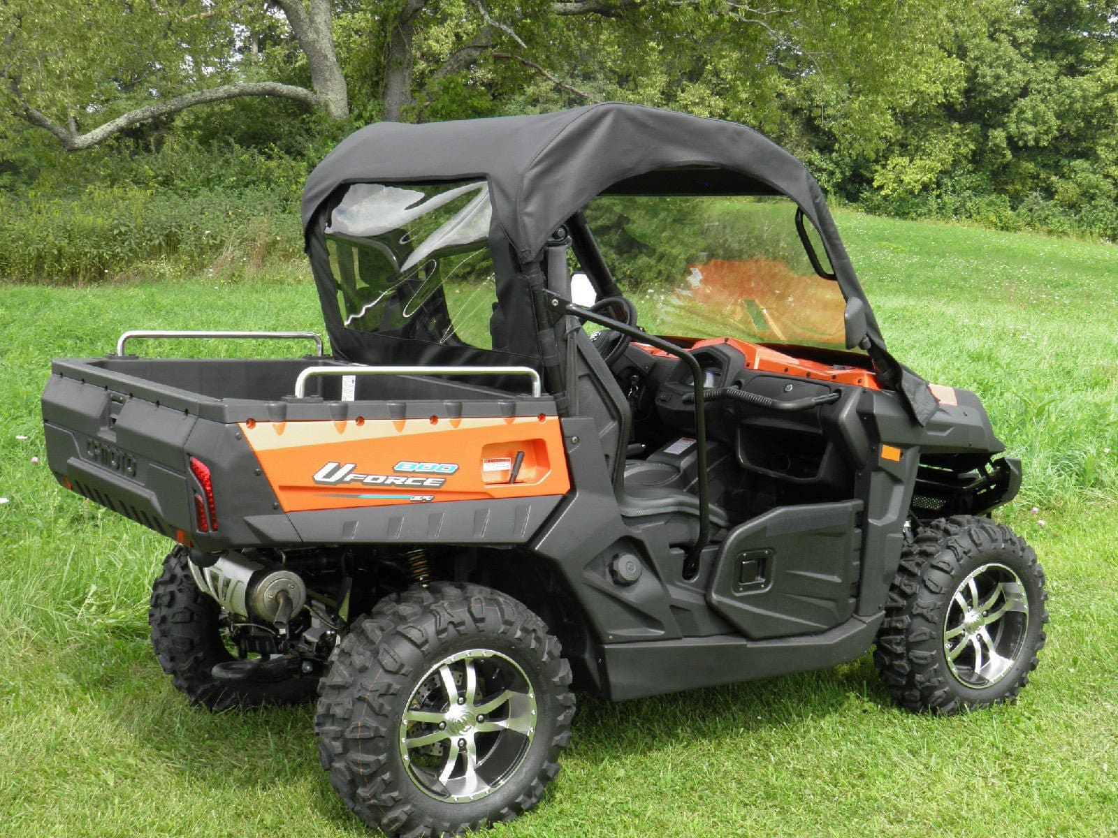 Orange and black UTV parked on grass
