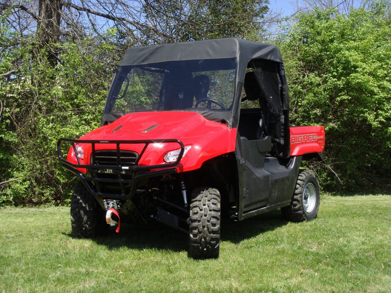 Red side-by-side utility vehicle on grass