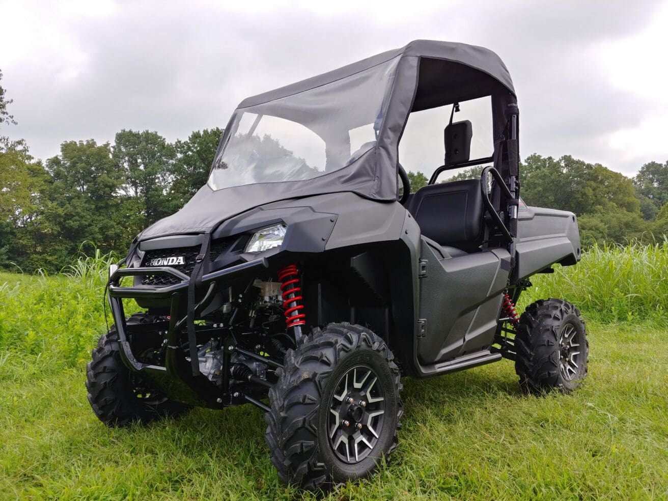 Black Honda side-by-side UTV on grass