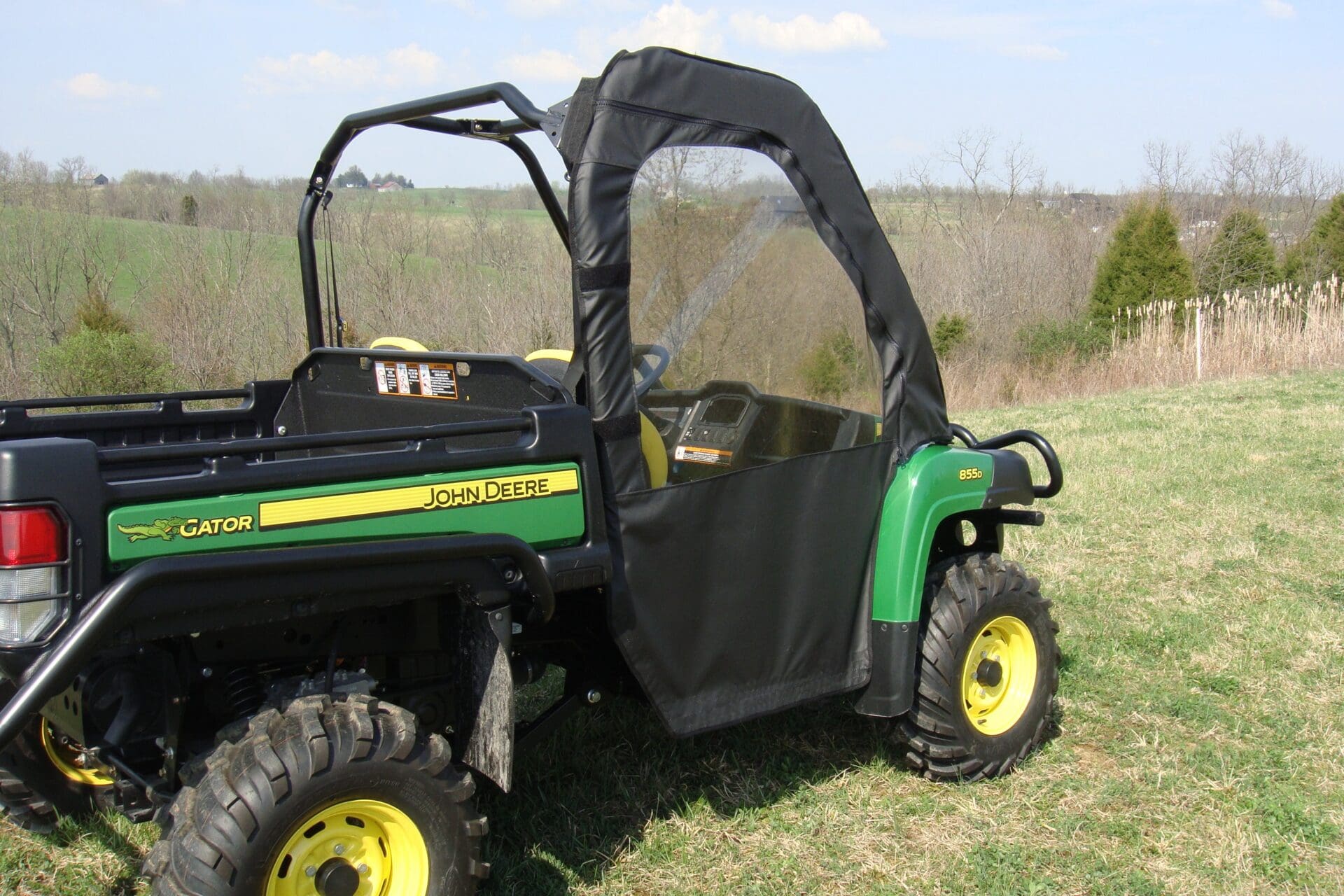 John Deere utility Gator parked in grassy field