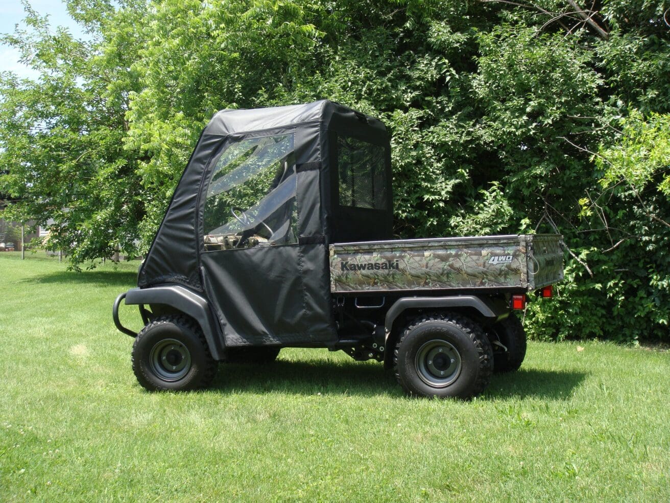 Kawasaki UTV with cab enclosure on grass