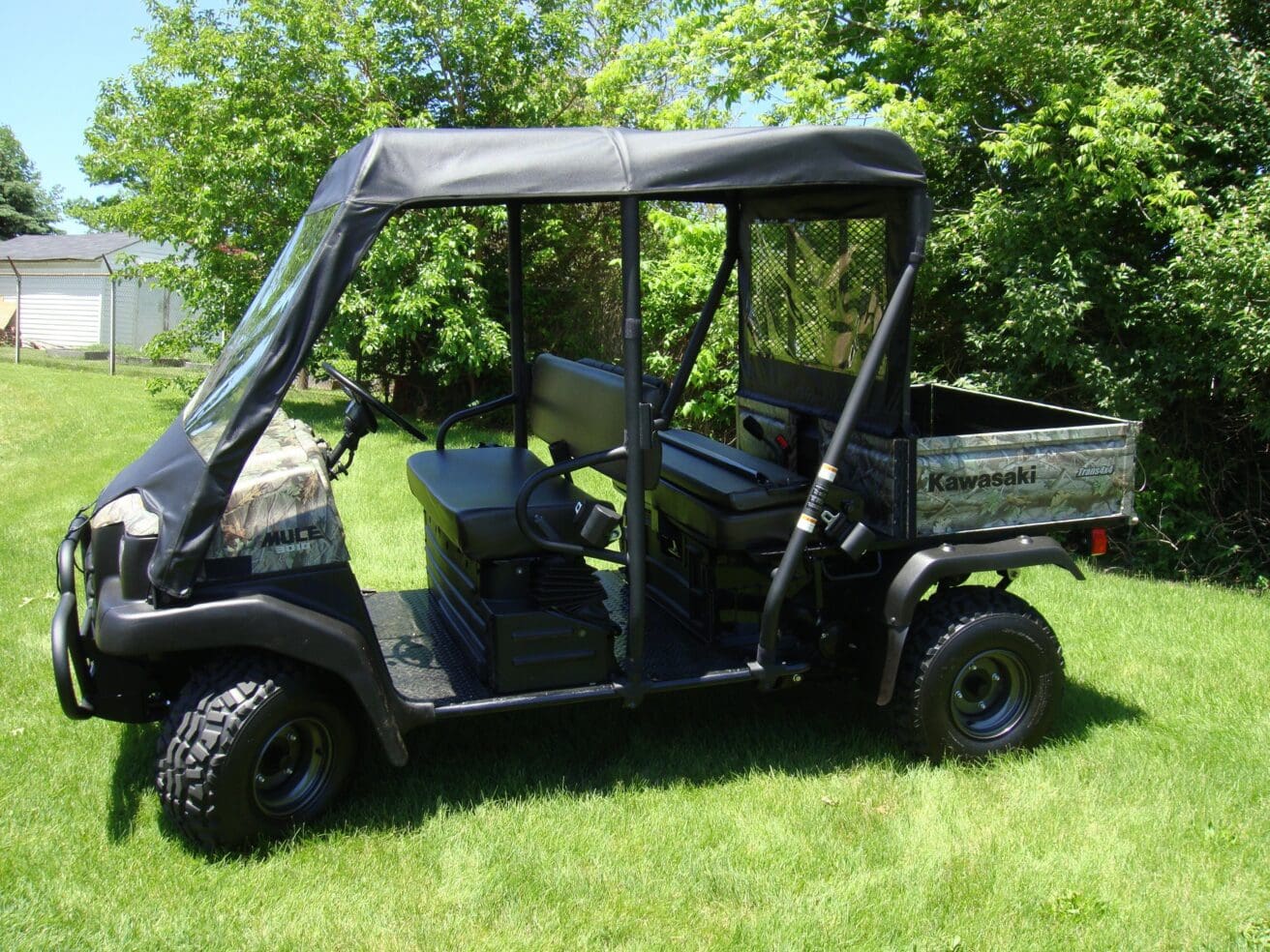 Kawasaki utility vehicle parked on grassy lawn
