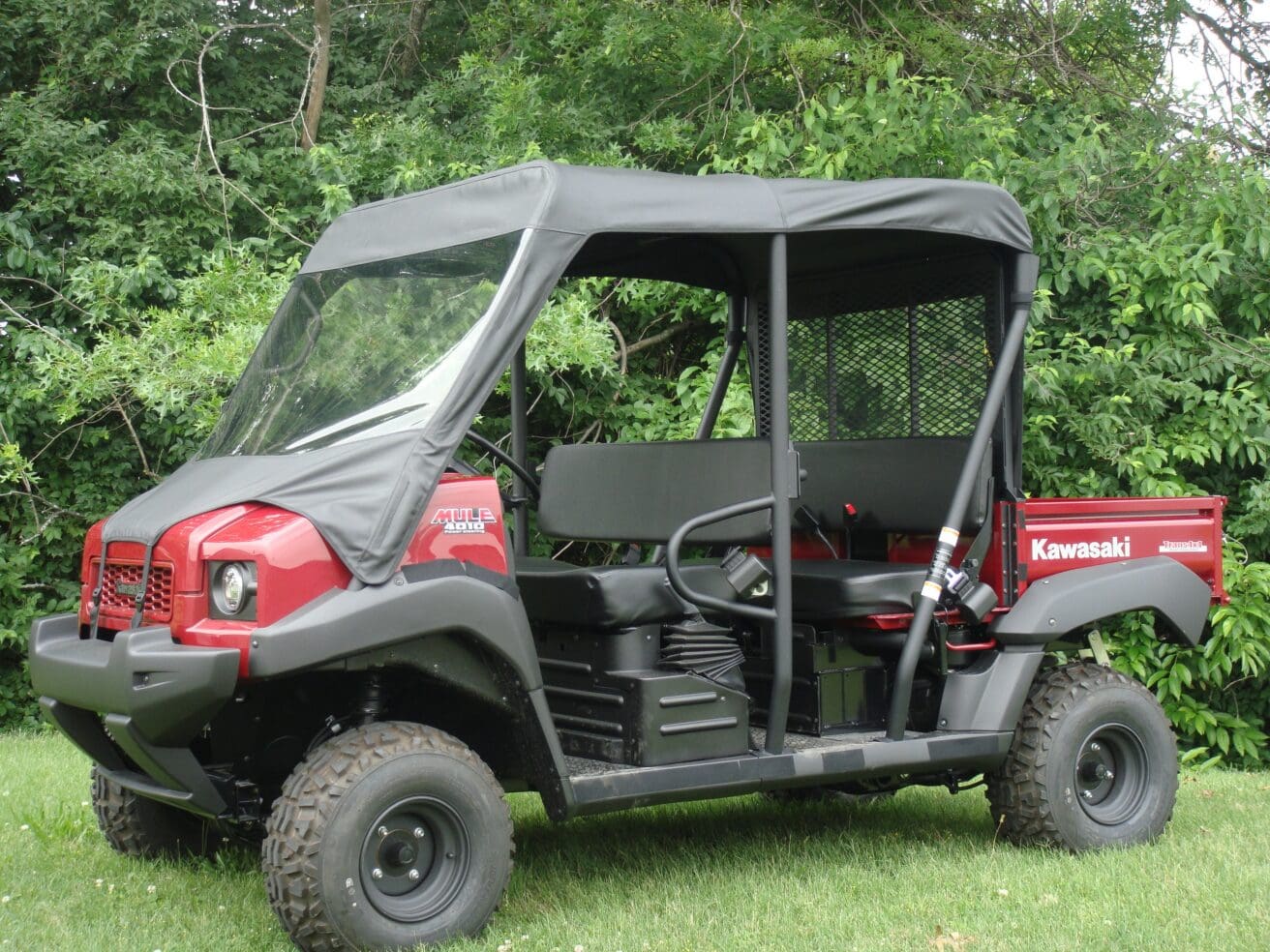Red Kawasaki utility side-by-side UTV with canopy