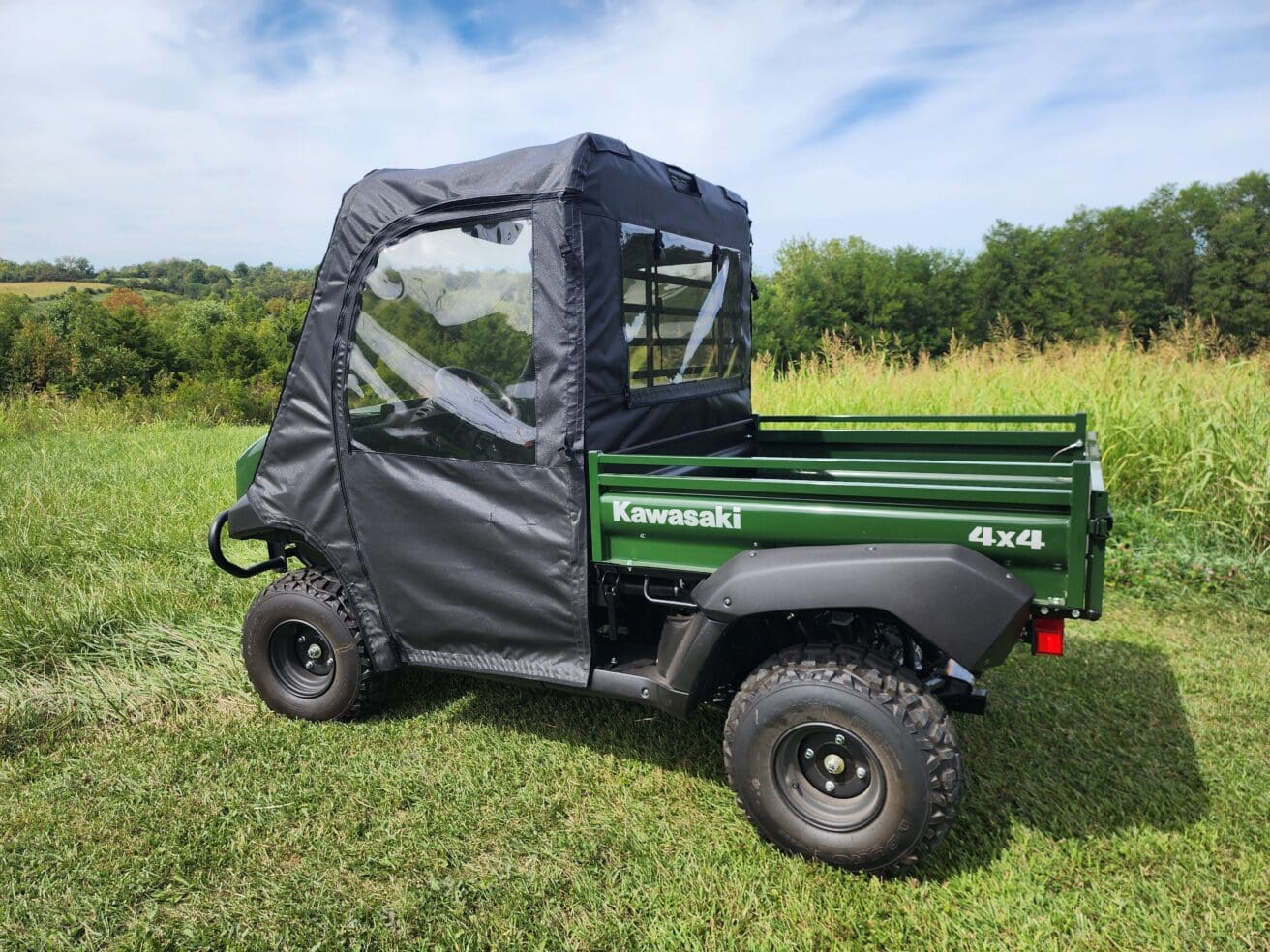 Green 4x4 Kawasaki vehicle in nature