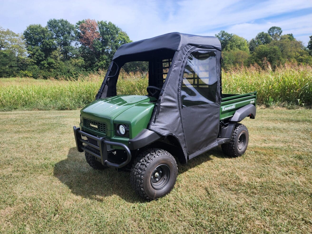 Green off-road utility vehicle on grass
