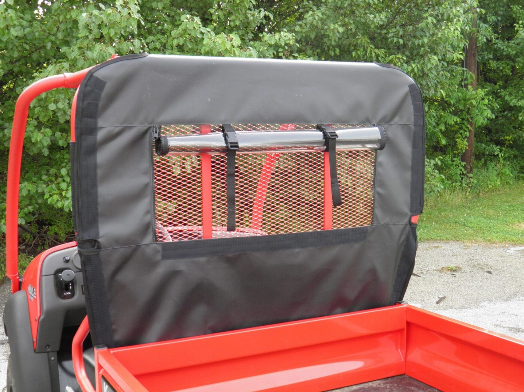 Red utility vehicle with black mesh rear panel