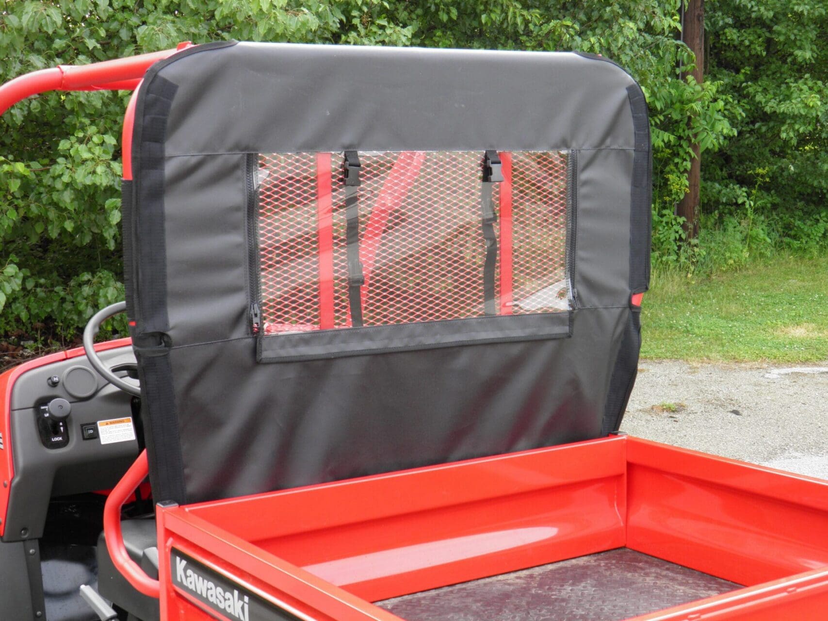 Red Kawasaki utility vehicle with mesh rear window