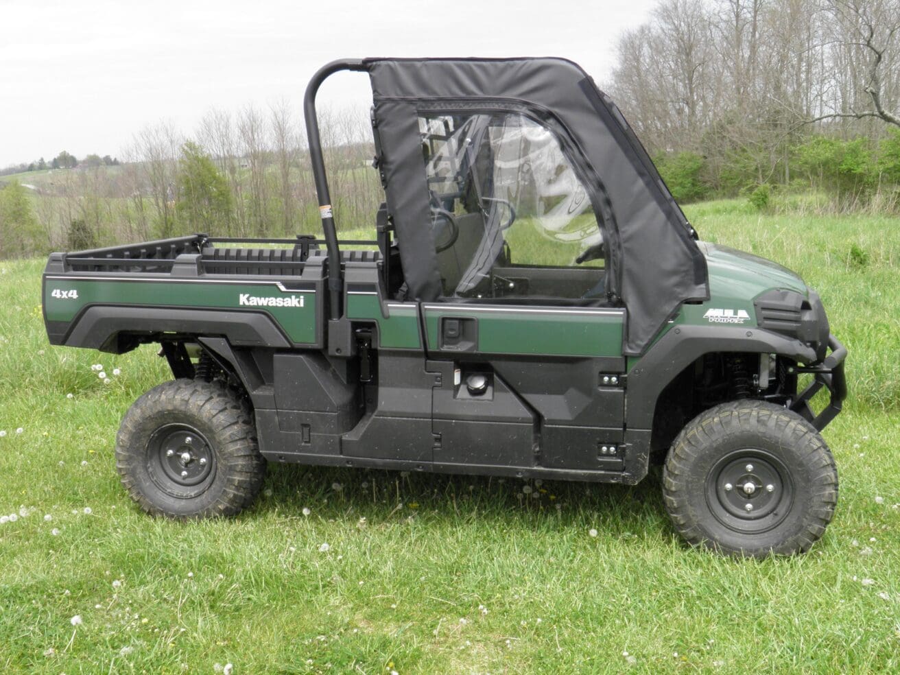 Kawasaki vehicle with full cab on grass