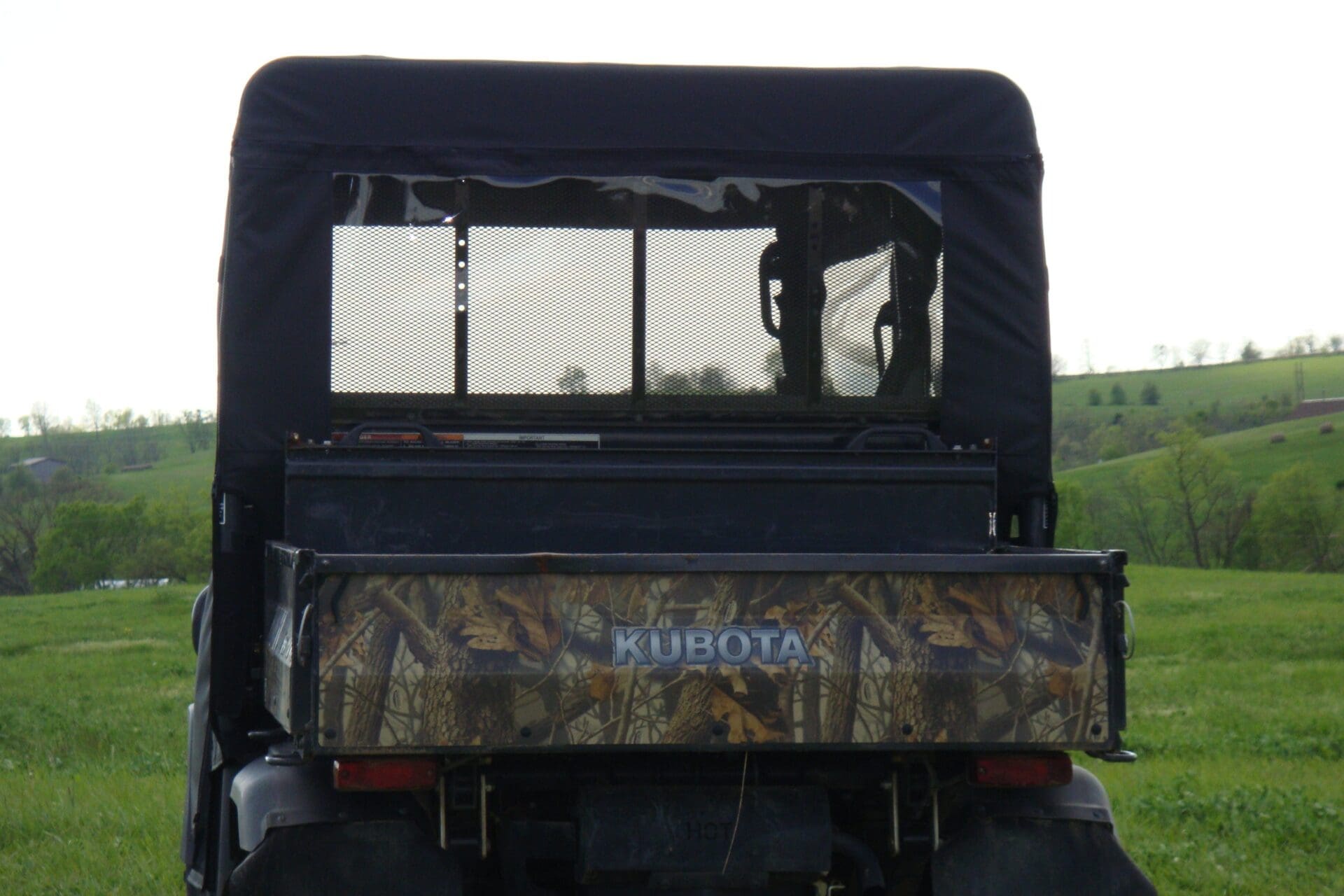 Utility vehicle with mesh rear window feature.