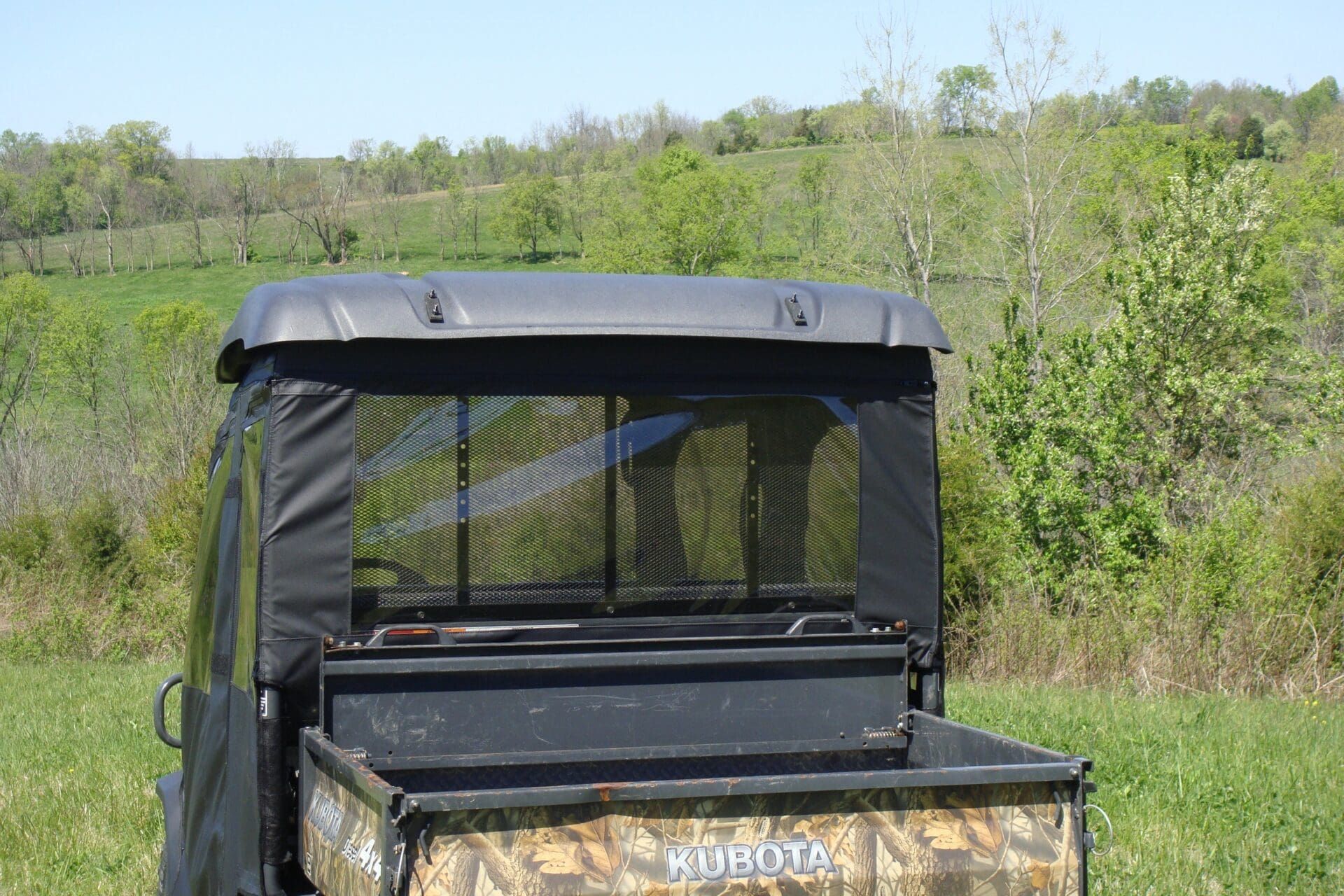 Zippered rear window on utility vehicle enclosure.